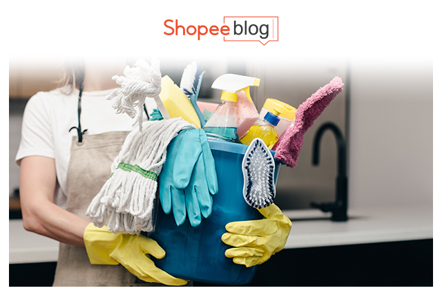 woman holding cleaning supplies