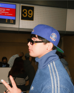 Maki Filipino singer with star pimple patch wearing a blue cap and sunglasses